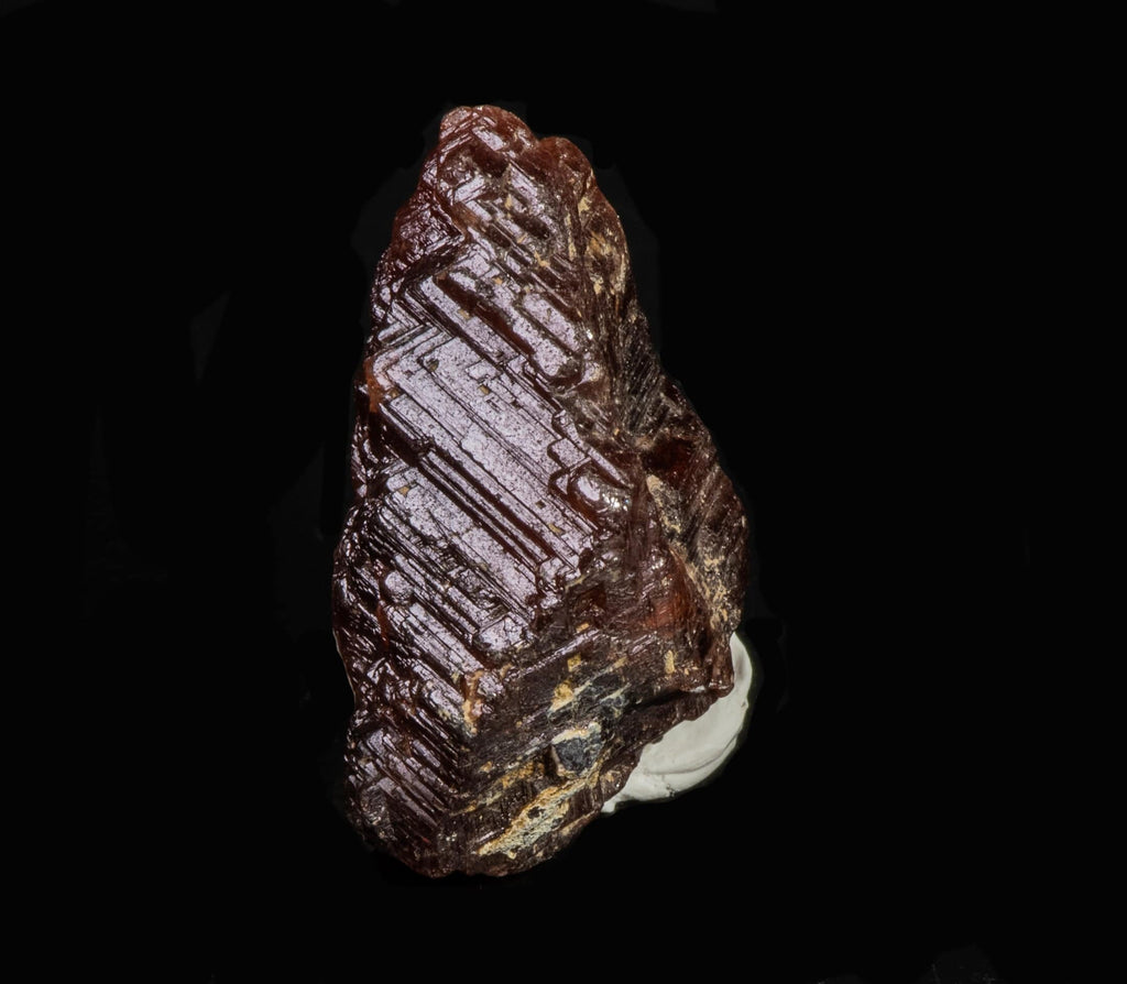 A nice, gemmy raw garnet crystal from Pocos dos Cavalos, Ceara, Brazil
