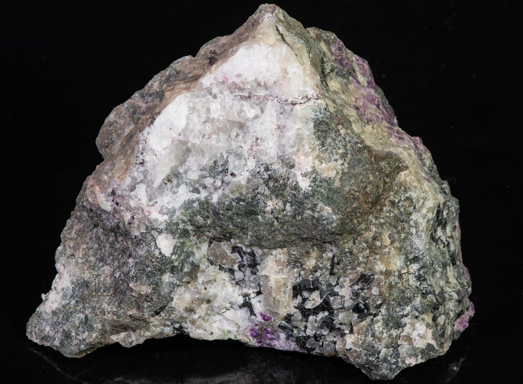 A large, tenebrescent fantasy rock with spectacular veined Tugtupite