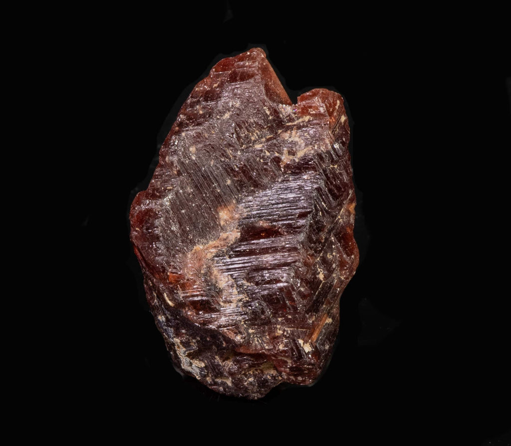A nice, gemmy raw garnet crystal from Pocos dos Cavalos, Ceara, Brazil